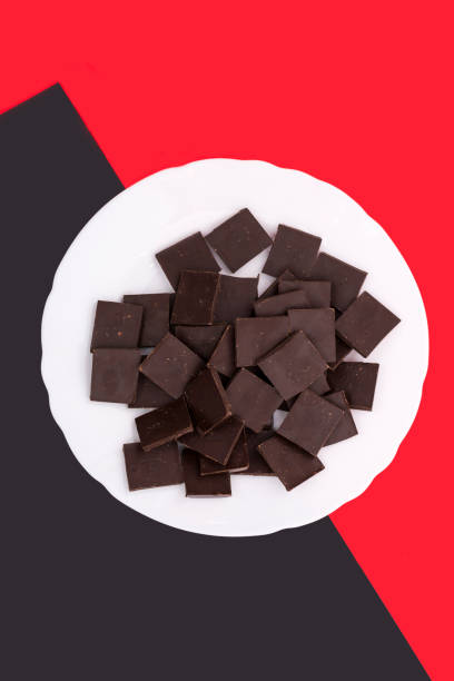 White plate with chocolate on a colored background