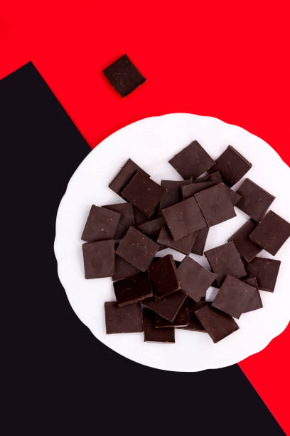 White plate with chocolate on a colored background