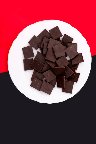 White plate with chocolate on a colored background