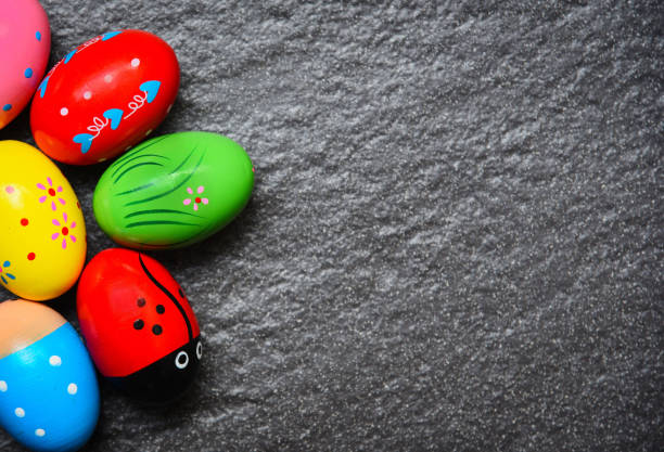 istock Easter eggs painted colorful on dark background - top view copy space 1129774222