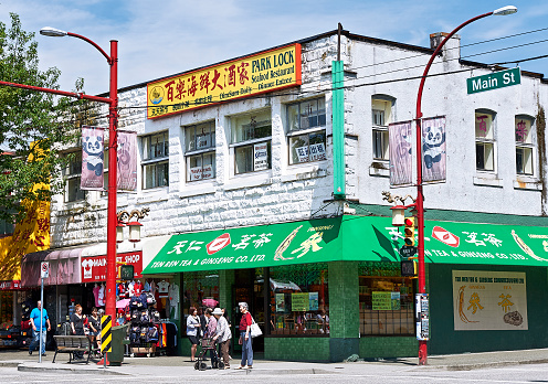 Vancouver, B.C., Canada - July 18, 2012: Detail view of a corner house with a chinese store at Main Street in Chinatown