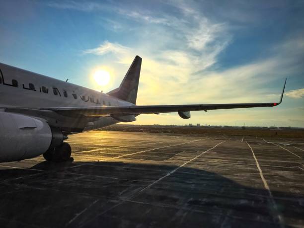 istock aircraft wing in the sun on the runway. 1129775181