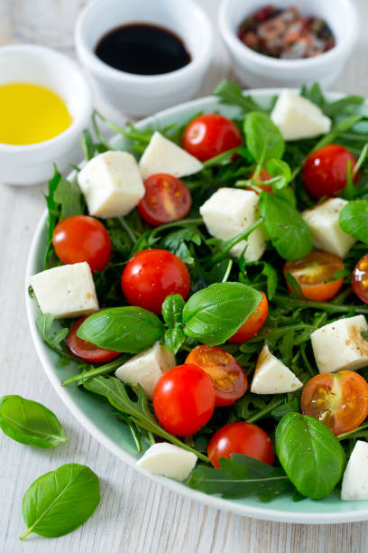 istock Vegetarian salad with cherry tomato, mozzarella and rucola 1129776184