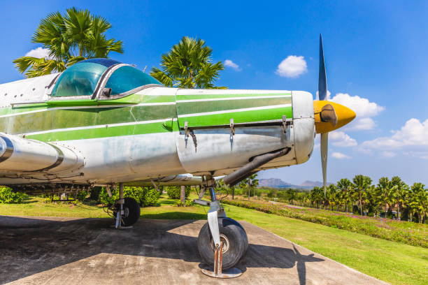 istock Colorful old airplane at park with gree tree and blue sky background 1129777671