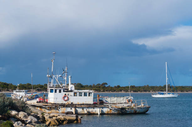 South Australia, Australia - July 30 2017: Working boat and yacht at American River's harbour on Kangaroo Island.