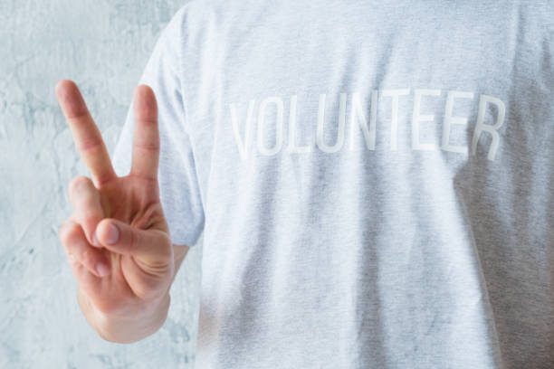 istock volunteering modern lifestyle man show v sign 1129785844