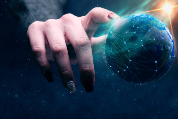 istock Woman touching planet with finger and network web and blue nebula dust. Mixed media. 1129786963