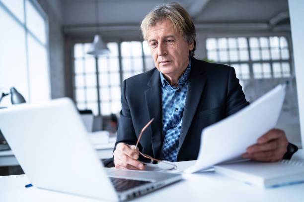 istock Senior businessman with glasess off in the office 1129788041