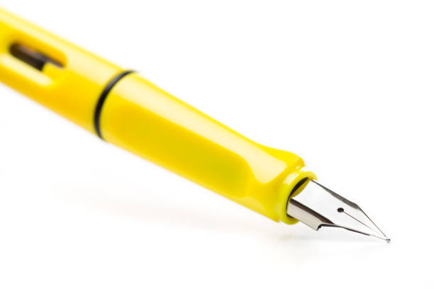 istock yellow modern fountain pen isolated on white, close up 1129790195