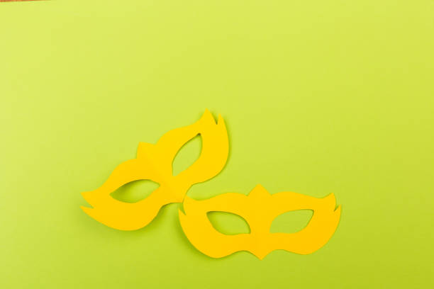 istock cut out colored paper figures for the holiday Mardi Gras, colour background 1129791092