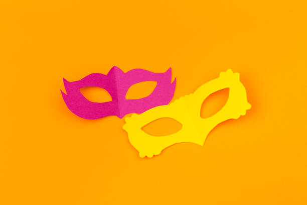 istock cut out colored paper figures for the holiday Mardi Gras, colour background 1129791098