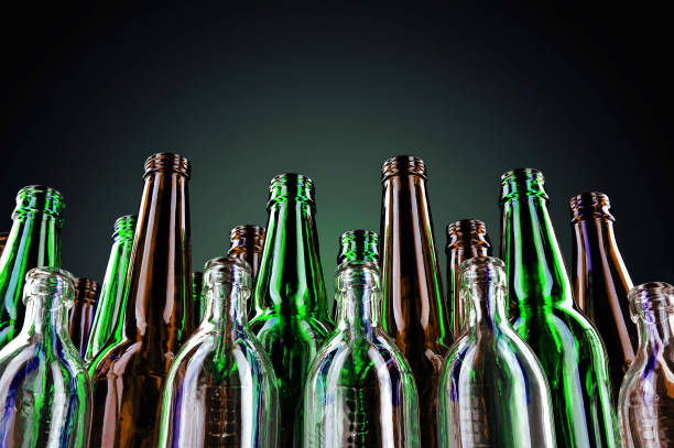 istock Empty and clean glass bottles on a dark background. 1129791864