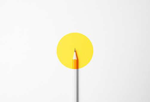 Yellow pencil on a white background, minimalism. Abstract art, imagination, education.