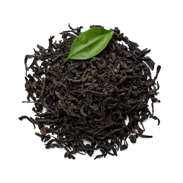 istock Dried black tea leaves isolated on white background. Top view. 1129792236