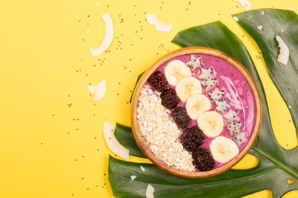 istock Smoothie bowl on yellow background 1129792313