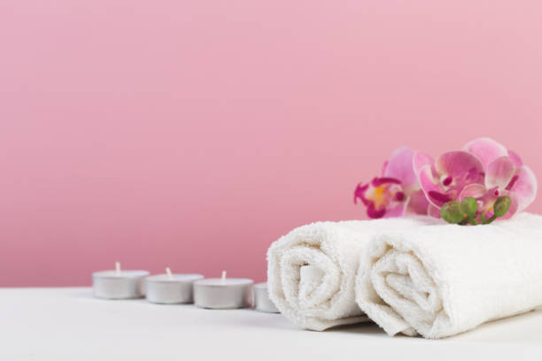 istock Spa still life with aromatic candles, flower and towel. - Image 1129792403