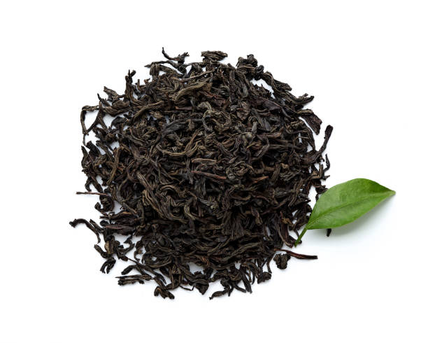 istock Dried black tea leaves isolated on white background. Top view. 1129793130
