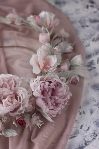 istock Pink silk flower wedding wreath on white background 1129793543
