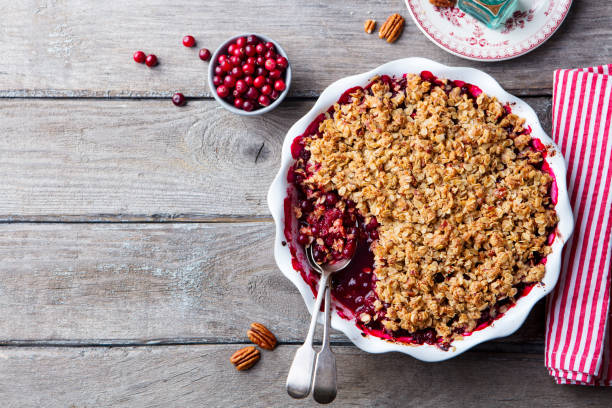 istock Cranberry crumble, crisp in a baking dish. Wooden background. Top view. Copy space. 1129796268