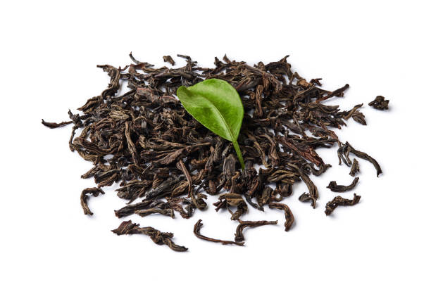istock Heap of dried black tea leaves isolated on white background. 1129797007