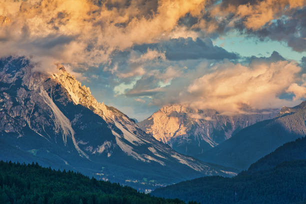 istock Mountain slopes in clouds at sunset, beautiful outdoor background 1129797098