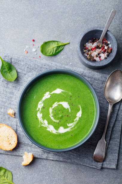 istock Broccoli, spinach cream soup in a bowl with toasted bread. Top view. Plant based diet. 1129797246
