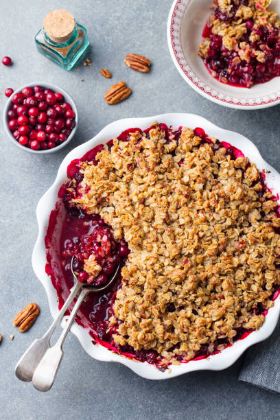 istock Cranberry crumble, crisp in a baking dish. Grey background. Top view. 1129797299