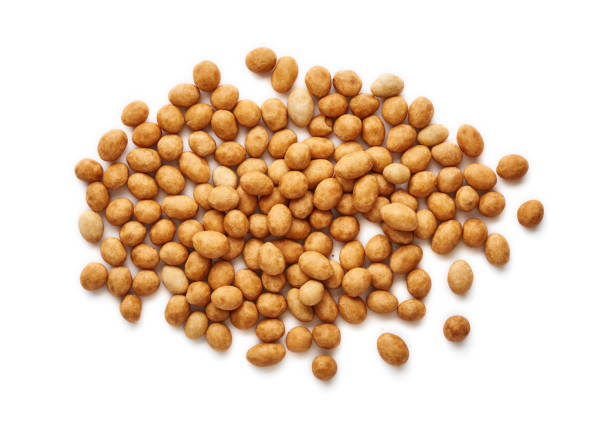 istock Spicy coated fried peanuts isolated on white background. Top view of snacks and nuts. 1129797434