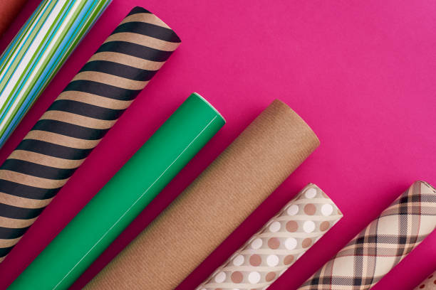 istock Pack your gifts with multicolored wrapping paper. Rolls of different wrapping paper. 1129798105