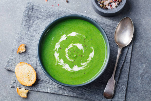 istock Broccoli, spinach cream soup in a bowl with toasted bread. Top view. Plant based diet. 1129798381