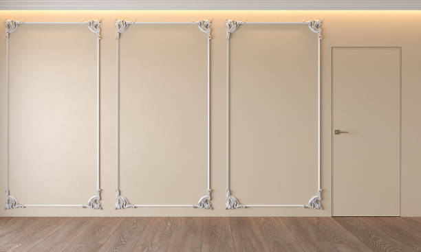 istock Modern classic beige interior with stucco, door, wooden floor, ceiling backlit, molding. Empty room, blank wall. 1129798446