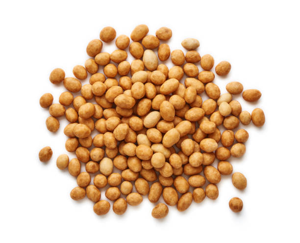 istock Spicy coated fried peanuts isolated on white background. Top view of snacks and nuts. 1129798548