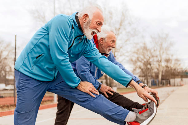 istock Two senior sportsman stretching 1129798747