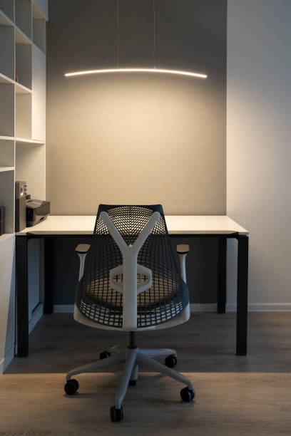 istock Modern office place with comfortable office workspace - computer desk, orthopaedic chair and right artificial light for work. 1129800520