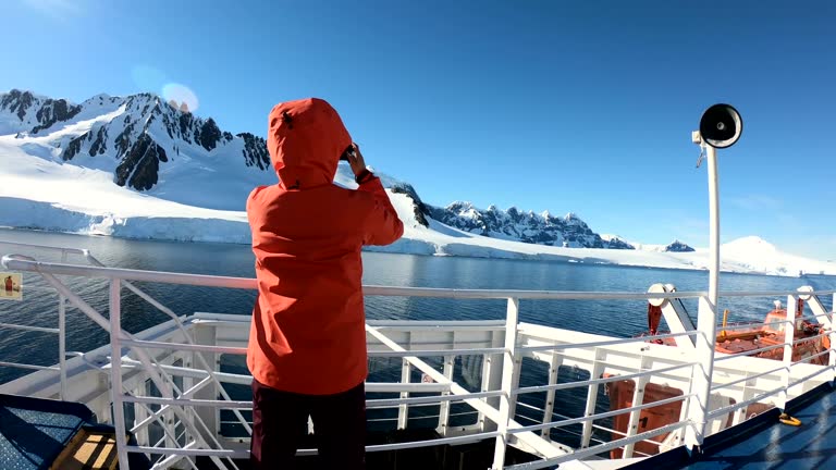 Women take pictures on an Antarctic ship