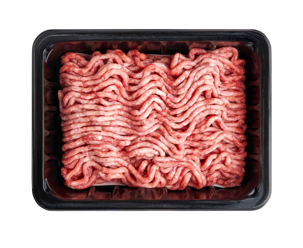 istock Black plastic tray with raw fresh pork minced meat isolated on white background. Packaging design for mock up. 1129803900
