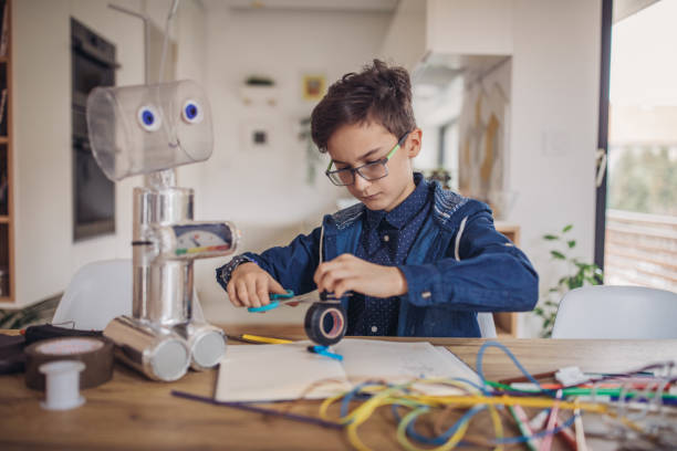 istock Little boy making robot toy 1129804720