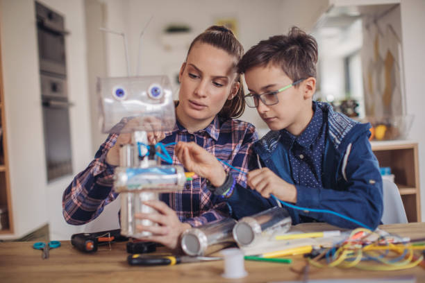 istock Boy making robot with his older sister 1129804795