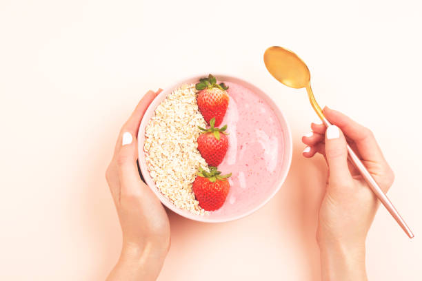 istock Smoothie bowl on yellow background 1129806137