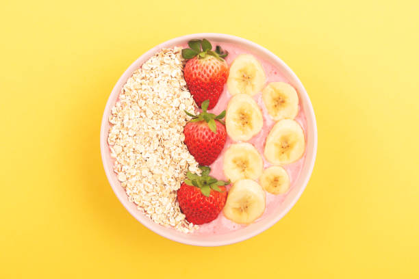 istock Smoothie bowl on yellow background 1129806163