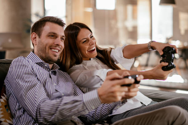 istock Happy couple playing video games 1129806291