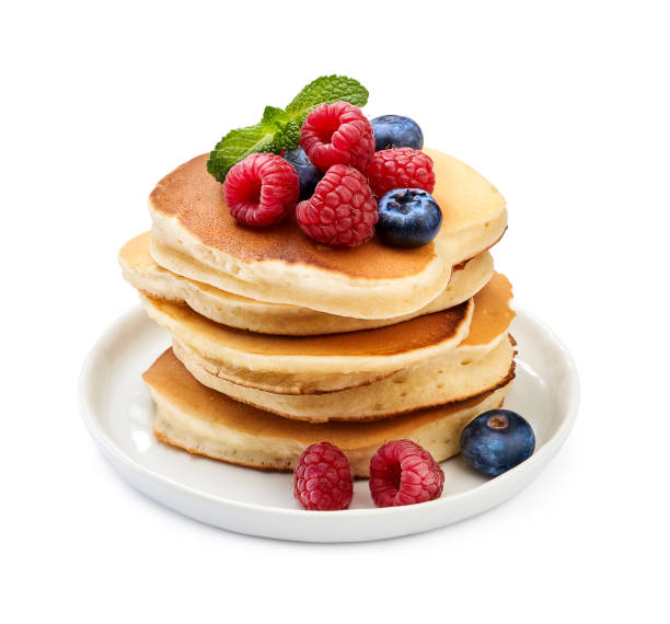 istock Stack of delicious pancakes with berries and mint leaf on plate isolated on white. 1129806301