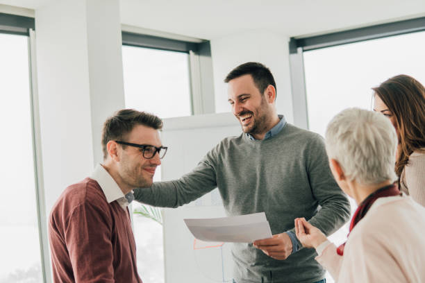 istock Smiling businessman with coworkers 1129806516