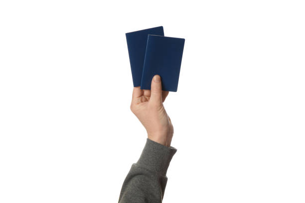 istock Blue passport in hand isolated on white background. Customs control and travel 1129806611