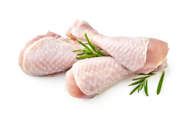 istock Raw chicken legs with rosemary isolated on white background 1129806787