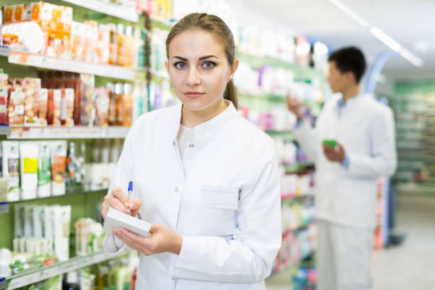 istock Woman pharmacist is inventorying medicaments 1129807365