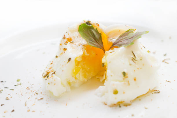 istock poached egg on a white plate, with celery leaves, sprinkled with spices 1129807476