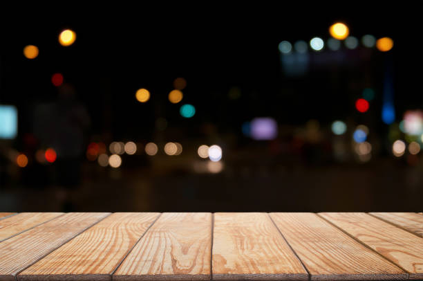 istock empty wood table in front of blurred montage night market bokeh background 1129807588