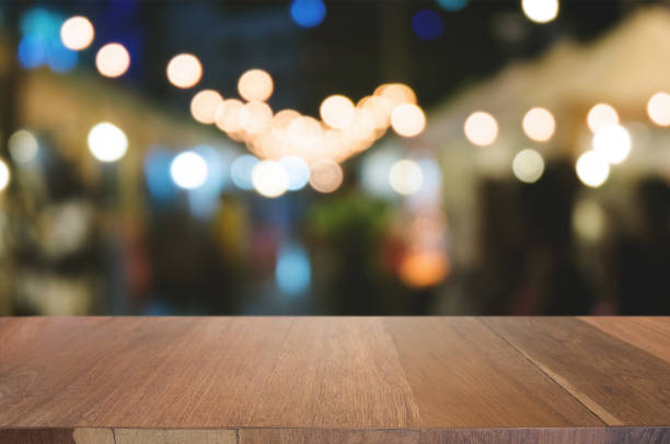 istock empty wood table in front of blurred montage night market bokeh background 1129807589
