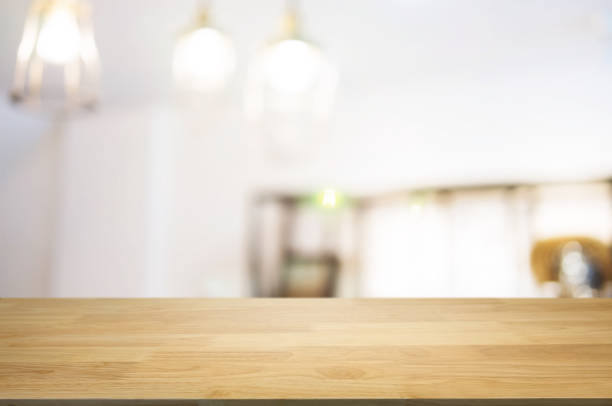 istock blank wooden table with blurred montage coffee shop cafe background 1129807592